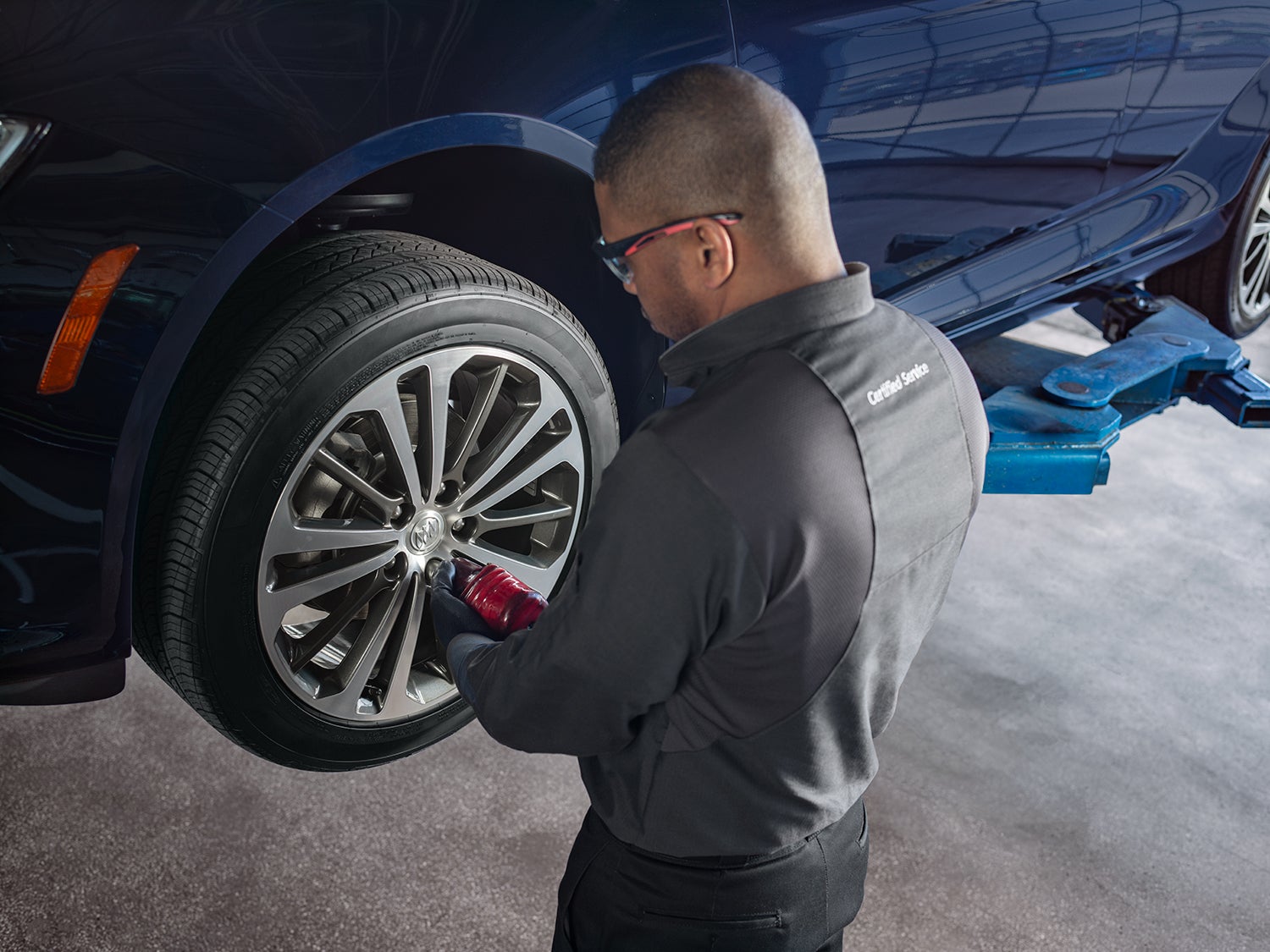 Buick service technician performs a tire rotation.