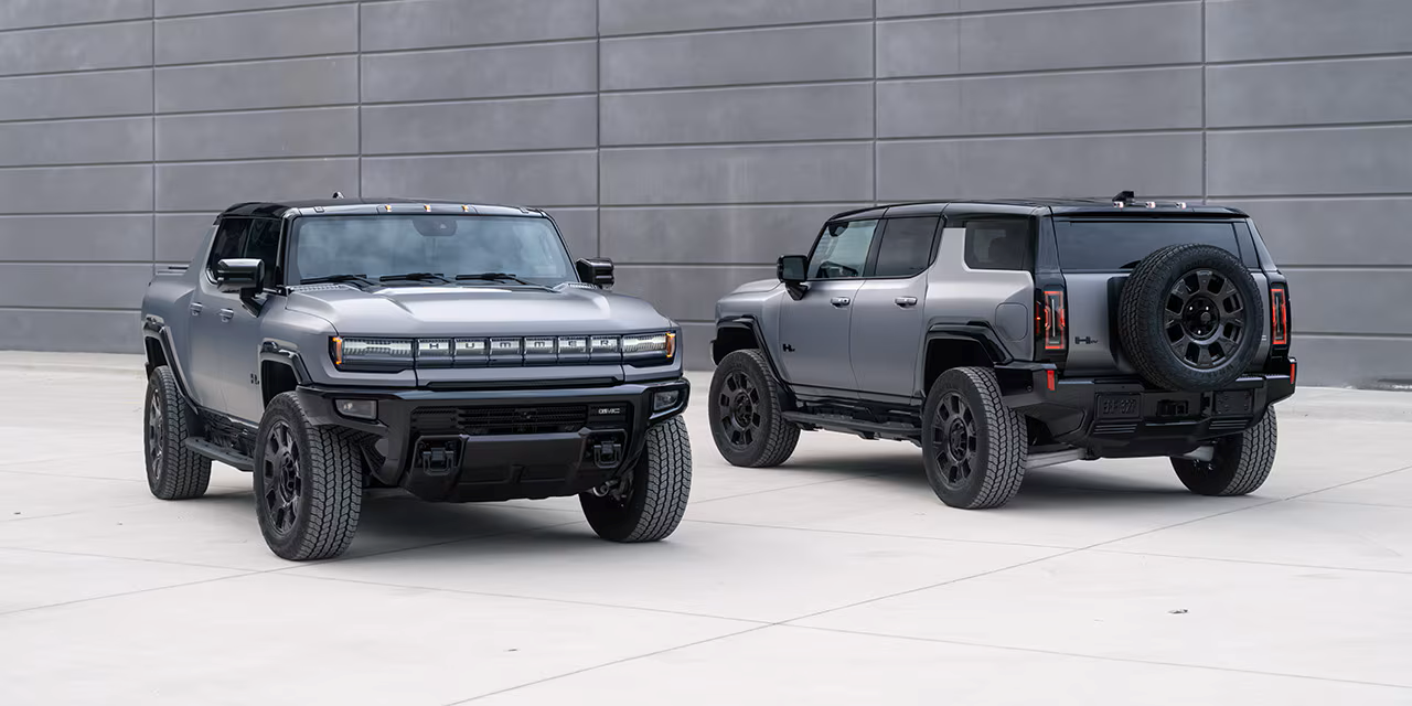 GMC HUMMER EV SUV and GMC HUMMER EV Pickup outdoors on asphalt