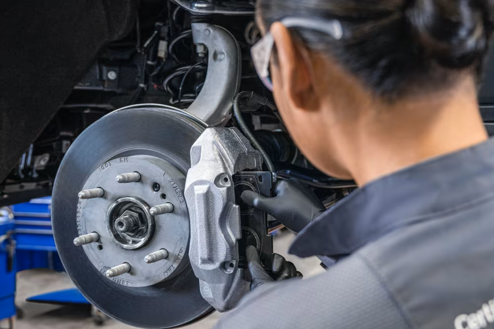 GM technician performing brake service