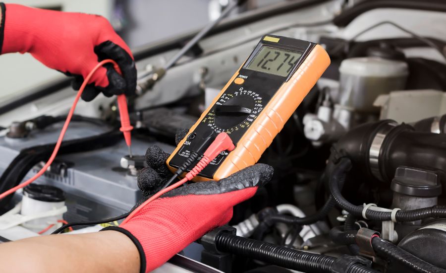 GMC service technician testing a battery