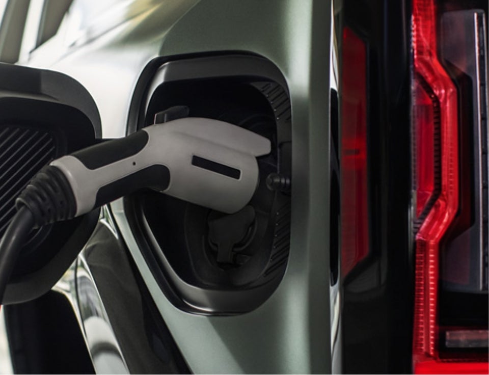 Close up of charging port with charger plugged in on a GMC Hummer EV SUV - Rick Weaver GMC in Erie PA