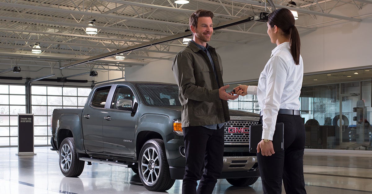 GMC salesperson with customer